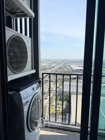 High-rise balcony with laundry appliances and stunning city view