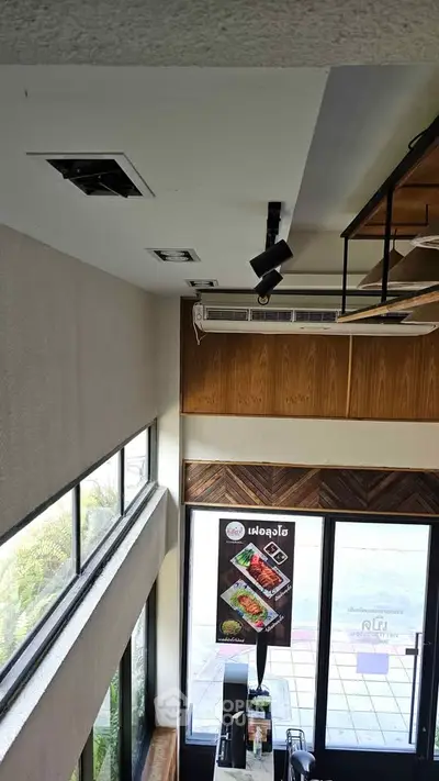 Modern commercial space with large windows and stylish interior design, perfect for a trendy business.