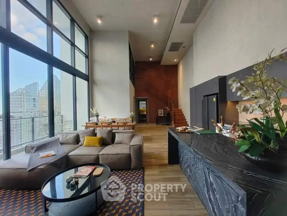 Luxurious modern living room with high ceilings and stunning city view