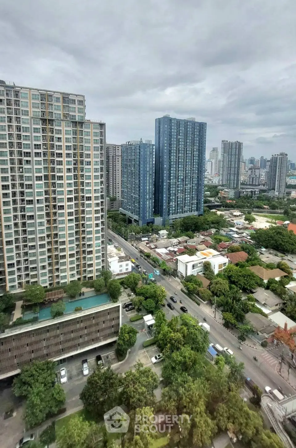 Stunning high-rise cityscape view showcasing modern residential buildings and lush greenery.