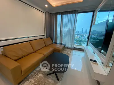 Modern living room with city view, featuring a sleek brown leather sofa and large TV.