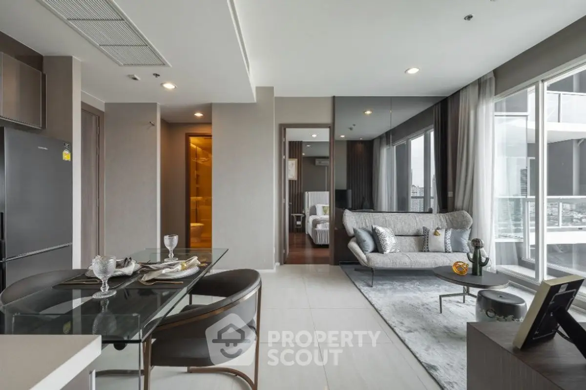 Modern open-plan living room with dining area and city view