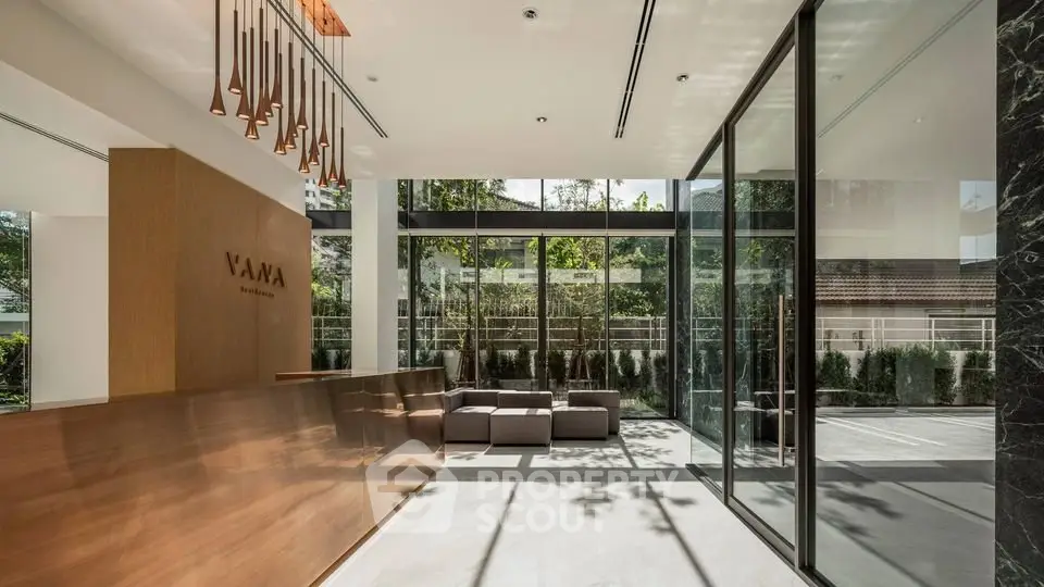 Luxurious modern building entrance with glass walls and stylish decor
