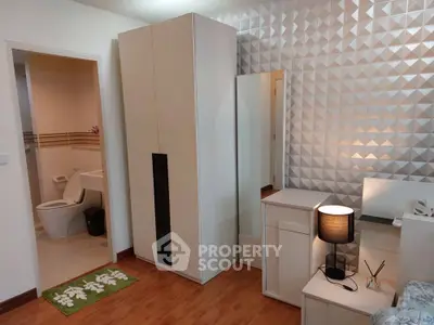 Modern bedroom with stylish geometric wall and sleek furniture