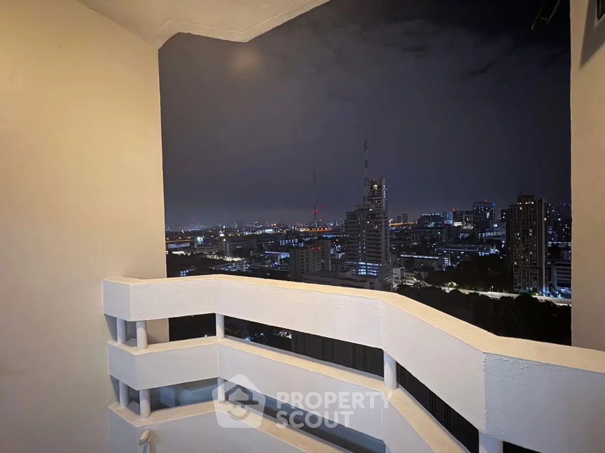 Stunning cityscape view from a high-rise balcony at night, perfect for urban living.