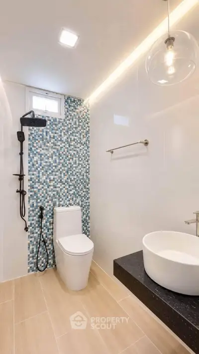 Modern bathroom with stylish mosaic tiles and sleek fixtures