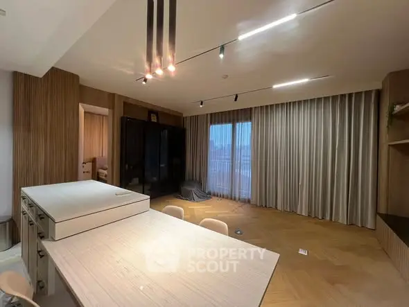 Spacious modern living room with elegant lighting and large windows