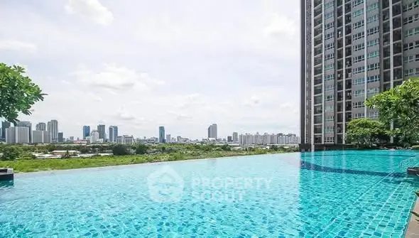 Luxurious high-rise apartment with stunning infinity pool and city skyline view.