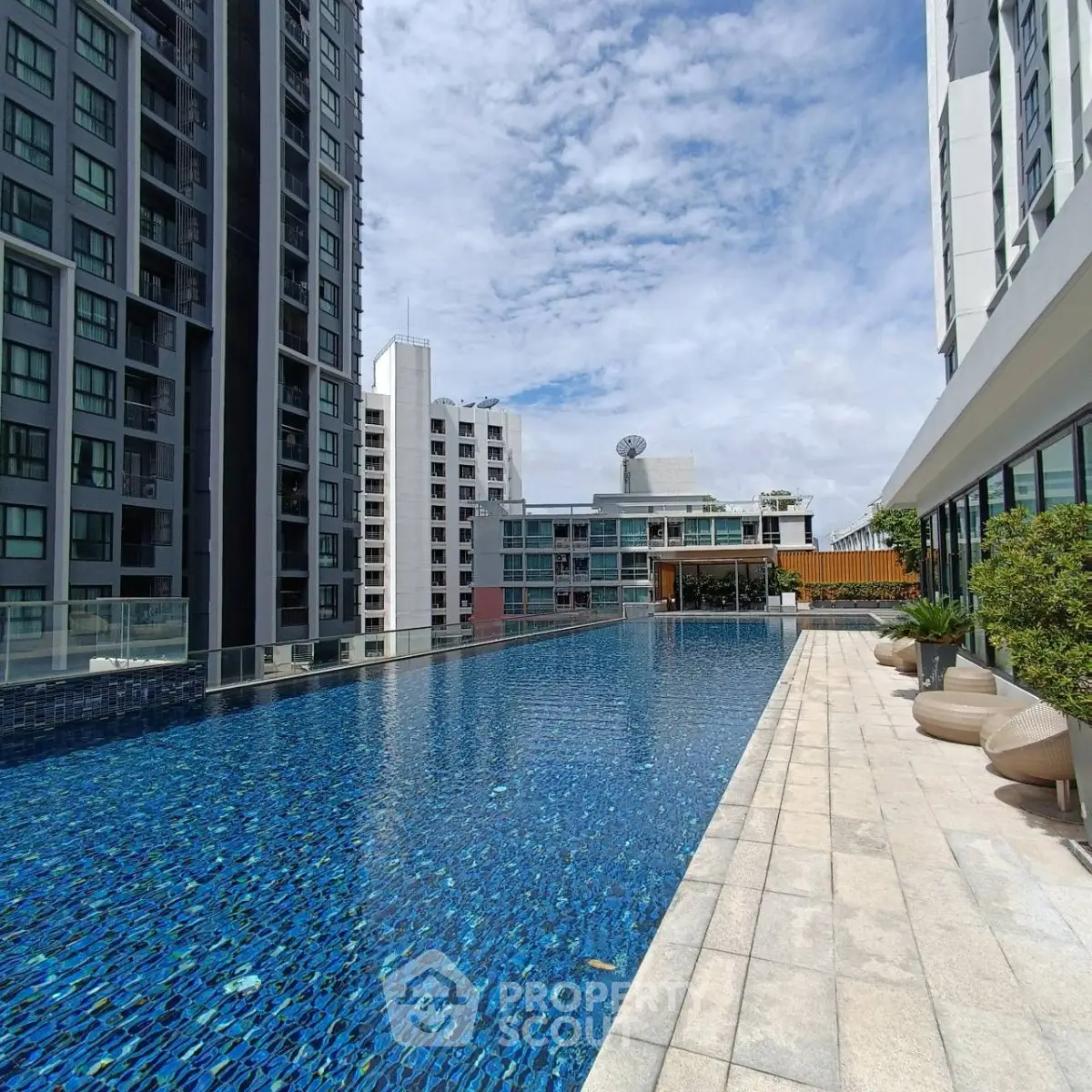 Luxurious rooftop pool with stunning city views in modern high-rise building.