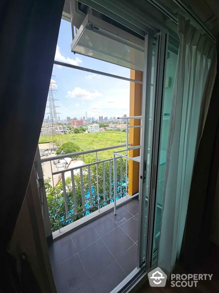 Charming balcony with city skyline view, perfect for relaxation and enjoying the outdoors.