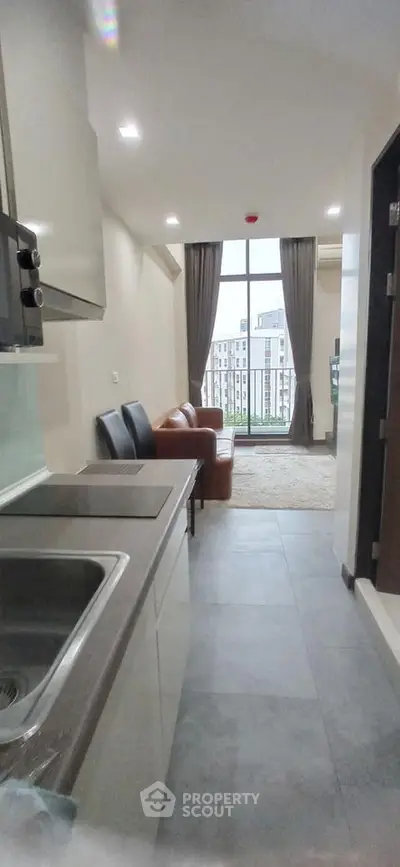 Modern apartment interior with open layout and city view balcony