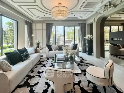 Luxurious living room with elegant decor, large windows, and stylish furniture in a modern home.