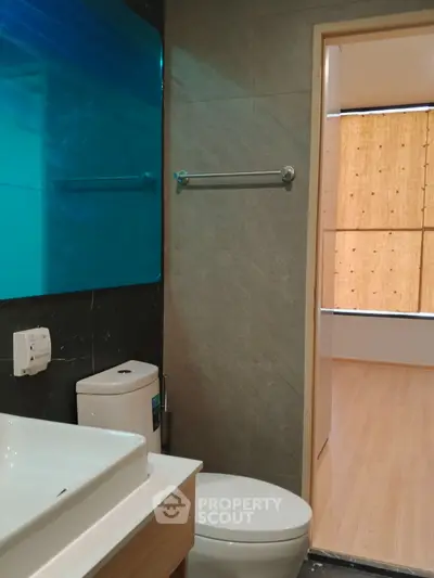 Modern bathroom with sleek design and adjacent room view