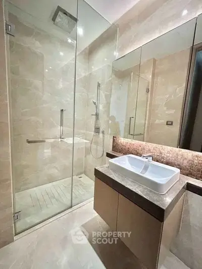 Luxurious modern bathroom with glass shower and elegant vanity