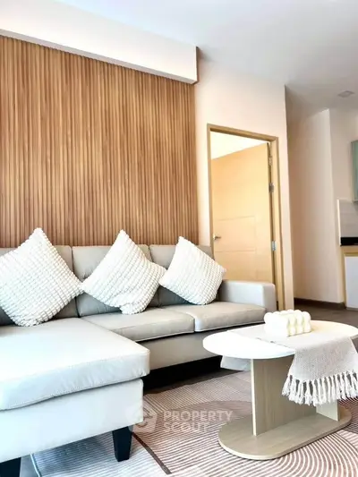 Modern living room with stylish sofa and wooden accent wall