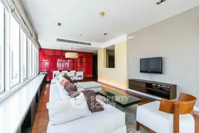 Spacious modern living room with large windows and stylish decor in a luxury apartment.