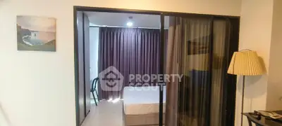 Modern bedroom with glass sliding doors and elegant decor in a stylish apartment.