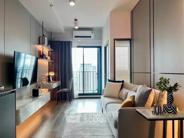 Modern living room with stylish decor and city view balcony in high-rise apartment.
