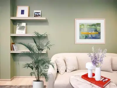 Stylish living room with elegant decor, featuring a cozy sofa, modern art, and lush indoor plant.