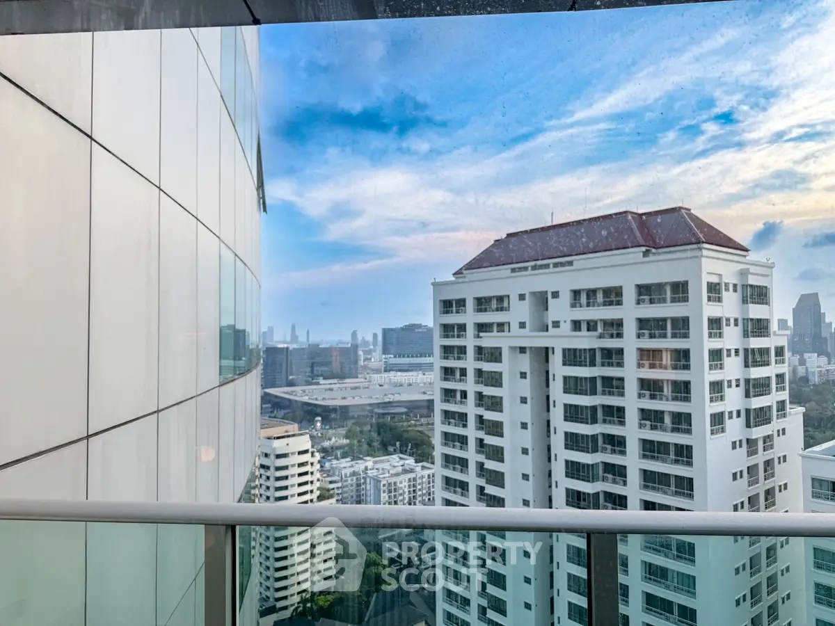 Stunning cityscape view from a high-rise balcony with modern architecture.