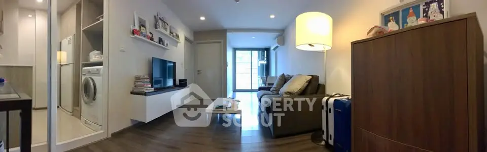Modern living room with sleek furniture and integrated laundry area, perfect for urban living.