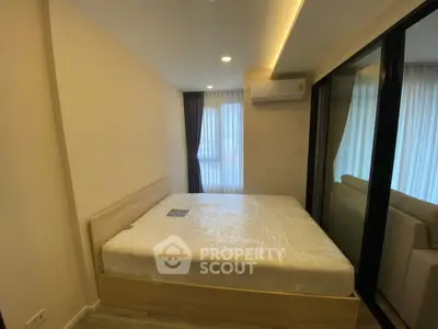 Modern bedroom with large window and air conditioning in stylish apartment