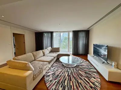 Spacious living room with modern decor and large windows offering natural light.