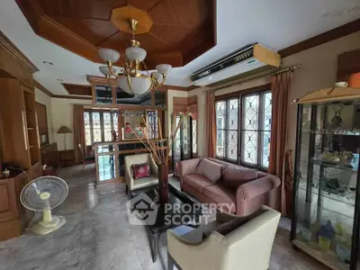 Spacious living room with elegant decor and large windows for natural light.