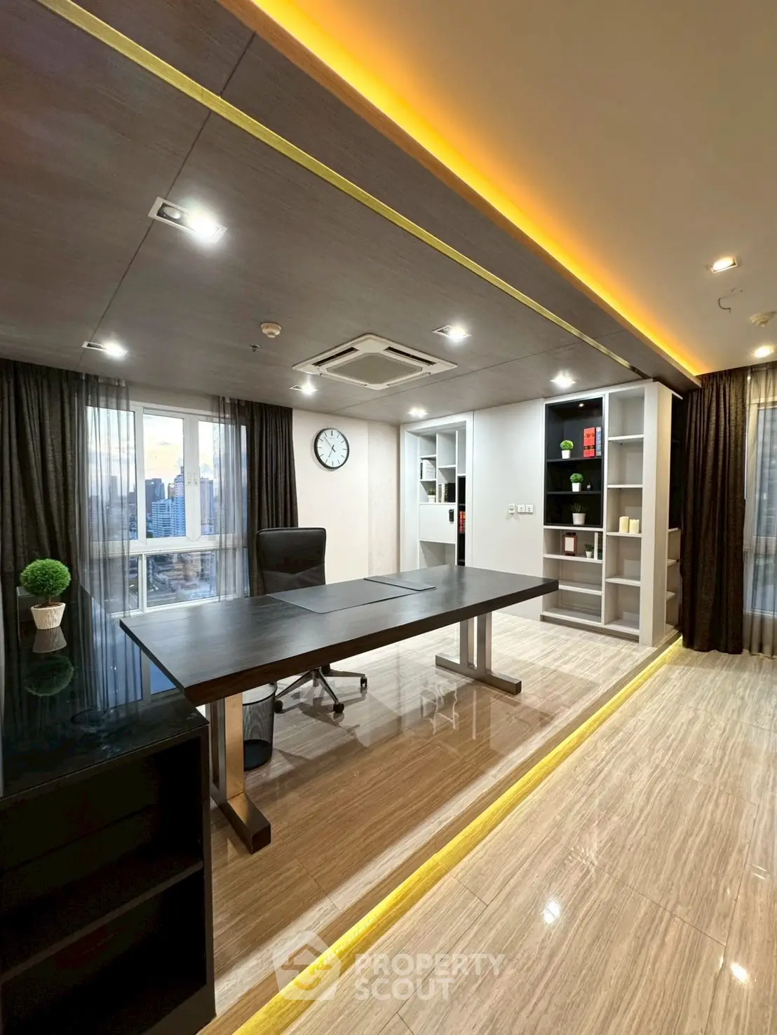 Modern study room with sleek desk and city view, featuring elegant lighting and stylish shelving.