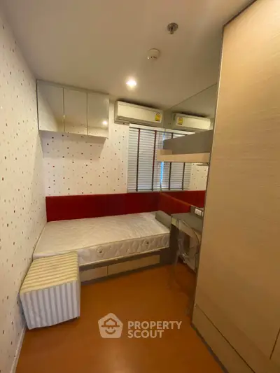 Cozy bedroom with modern design, featuring built-in storage and stylish decor.