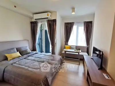 Modern bedroom with cozy decor and natural light, featuring a comfortable bed and stylish furnishings.