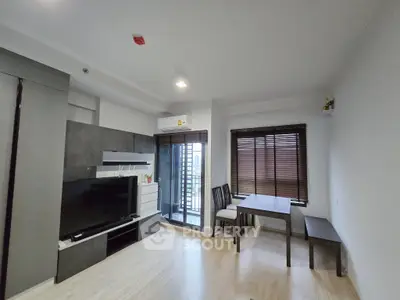 Modern living room with sleek furniture and balcony view in a stylish apartment.