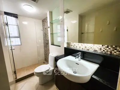 Modern bathroom with sleek fixtures and glass shower enclosure