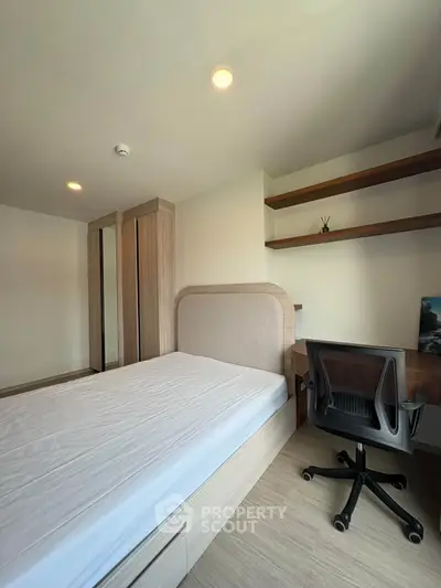 Modern bedroom with sleek furniture and built-in storage, perfect for urban living.