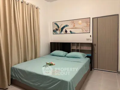 Cozy bedroom with modern decor and elegant artwork above bed