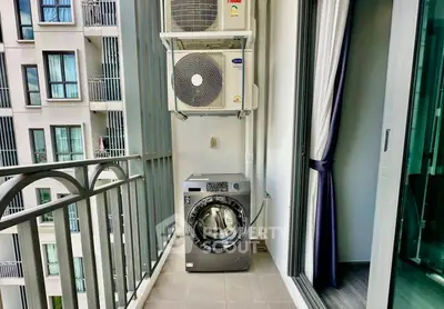 Modern balcony with washing machine and air conditioning units in urban apartment.