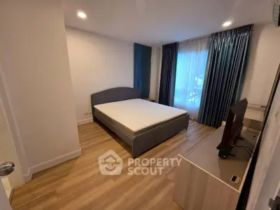 Modern bedroom with stylish decor and natural light