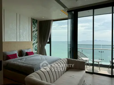 Luxurious bedroom with stunning ocean view and spacious balcony in modern apartment