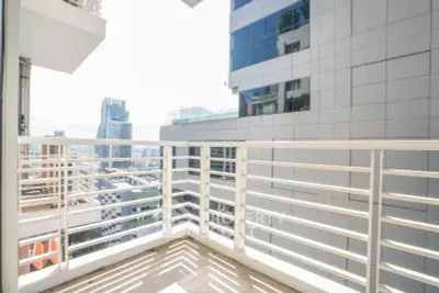 Spacious balcony with stunning city view in modern high-rise building.
