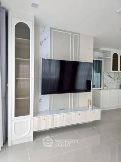 Modern living room with sleek TV setup and elegant marble accents