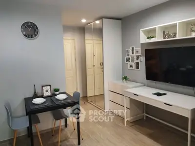 Modern living room with sleek furniture and wall-mounted TV, perfect for cozy urban living.