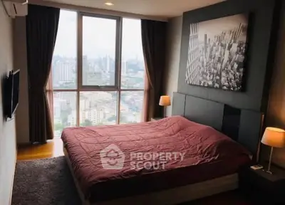 Luxurious bedroom with stunning city view from floor-to-ceiling windows, modern decor, and cozy ambiance.