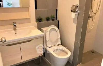Modern bathroom with sleek fixtures and walk-in shower in contemporary apartment.