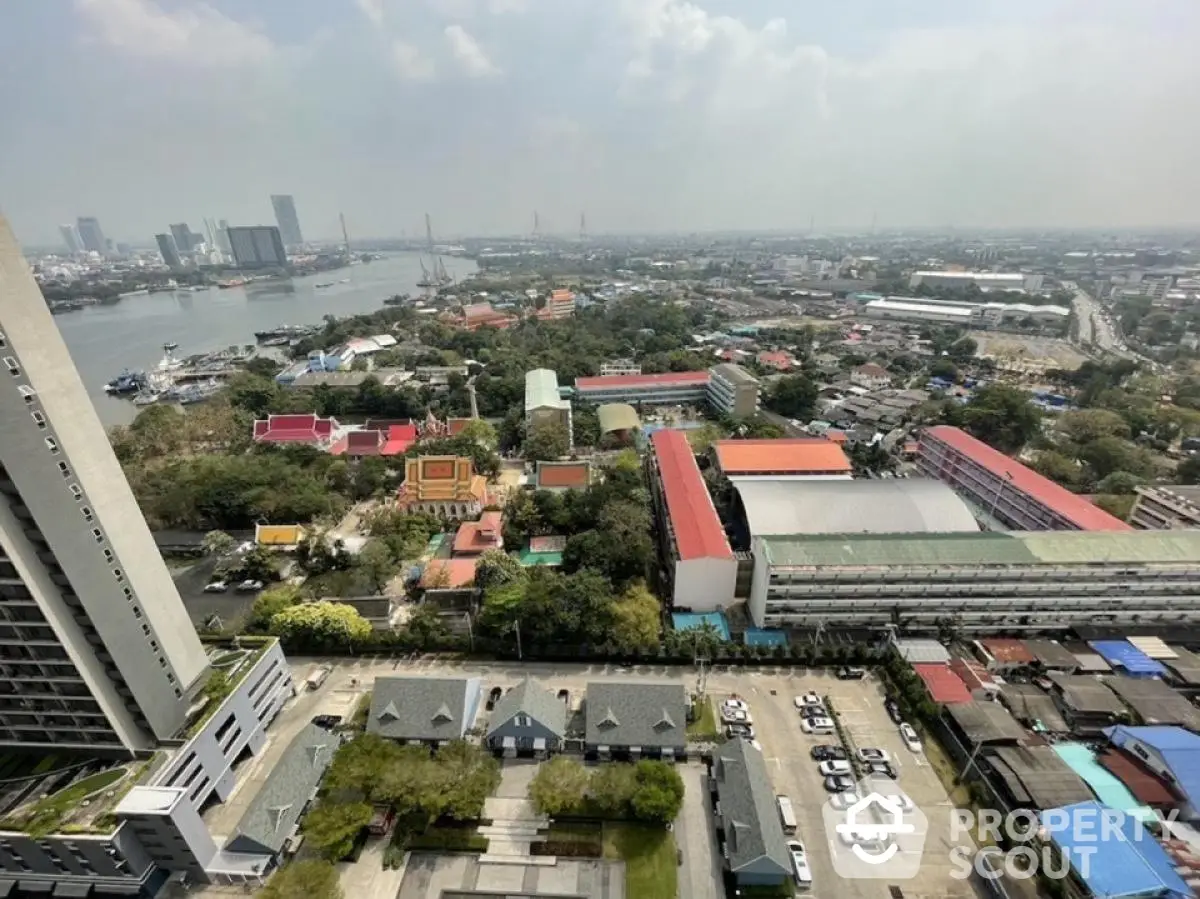 Stunning aerial cityscape view with river and skyline, perfect for urban living enthusiasts.