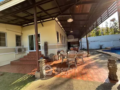 Charming outdoor patio with poolside view and stylish seating area