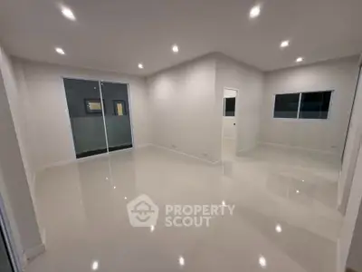 Spacious modern living room with sleek design and ample lighting