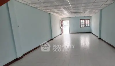 Spacious empty room with tiled flooring and natural light