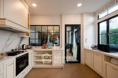 Luxurious kitchen with modern appliances and elegant cabinetry, featuring a sleek open layout and natural light.