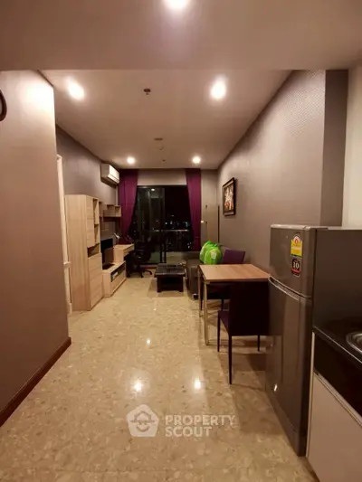 Modern living room with dining area and city view, featuring sleek furniture and ambient lighting.