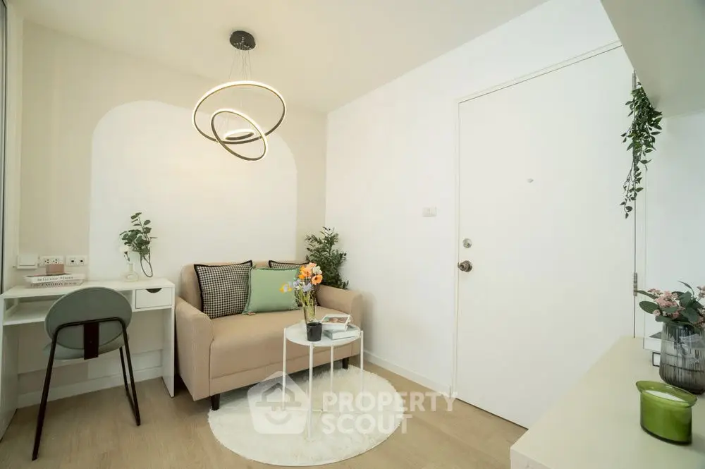 Chic modern living room with cozy sofa and stylish lighting in a compact apartment.